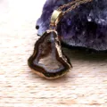 Natural agate geode slice pendant detail with gold electroplated bezel and fine chain display. - Pendant Only (Without Chain) / Coffee