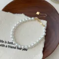 Élégant bracelet de perles blanches pour femmes avec charmant cœur et fermoir doré chic. - Argent 925 / 6mm / Or