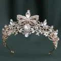 Close-up of golden baroque rhinestone bridal tiara with elegant bow and sparkling crystals. - H1557 KC Gold with White Rhinestones