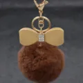 Close-up detail of fluffy brown faux fur keychain with sparkling rhinestone bow and gold hardware. - Bowknot Style - Artificial Rex Rabbit Fur / Coffee