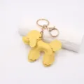 Yellow leather poodle keychain detail view, cute fluffy puppy bag charm for car keys and purses. - Yellow