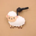 Detailed close-up of cute sheep leather bag charm with black strap, ideal accessory. - Side-Standing Little Sheep Charms / White