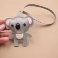 Cute grey koala leather bag charm detail, cartoon animal plush pendant close-up display. - Lanyard / Gray