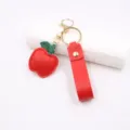 Cute red apple leather keychain with wrist strap and gold metal hardware ring accessory. - Red