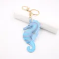 Leuk blauw lederen zeepaardje sleutelhanger met gouden metalen ring voor je handtas. - Blauw