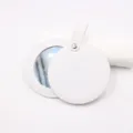 Portable round pocket mirror with white leather case and metal snap strap for makeup. - White