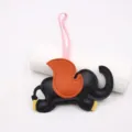 Detail view of the cute flying elephant leather bag charm with colorful contrast design. - Black