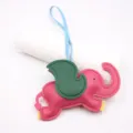 Detailed view of the cute pink and green leather elephant bag charm with a blue strap. - Rose Red