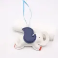 Close-up of cute cartoon elephant leather bag charm with blue and white color block design. - White