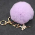Llavero de pompón morado y esponjoso con colgante de bailarina con strass para bolso. - Bailarina - Pelo de conejo Rex sintético / Púrpura Taro
