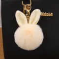 Fluffy rabbit ear pom pom keychain and bag charm, soft faux fur pendant with gold clasp. - Off White