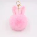 Cute pink rabbit ear plush pom pom keychain accessory for bags and keys, fluffy faux fur charm. - Pink