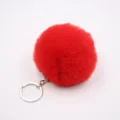 Close-up view of the red faux fur pom pom keychain, soft fluffy plush ball with silver metal ring. - 8cm Faux Fur + Single Ring Clasp / Red