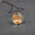 Close up detail of dried flower resin pendant, handmade nature style necklace jewelry. - 30mm / Orange