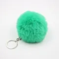 Close-up detail of the vibrant green fluffy faux fur pom-pom keychain with silver metal ring. - 8cm Faux Fur + Single Ring Clasp / Verdant