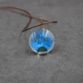 Resin dried flower pendant necklace close-up, handmade botanical jewelry with brown cord. - 30mm / Sapphire Blue