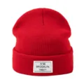 Close-up detail of the red knit beanie with woven patch and Brooklyn letter logo design. - One Size / Red