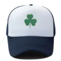 Detailed shot of the white and dark blue trucker hat featuring a green shamrock print. - Adjustable / Navy White
