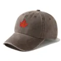Close-up detail of the washed vintage brown baseball cap with red maple leaf design. - Adjustable / Coffee