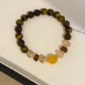 Detailed close-up of tiger eye crystal beaded bracelet in brown tone for women style jewelry. - Bracelet - Brown - Yellow
