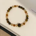 Detailed close-up of a vintage retro tiger eye stone and brown crystal beaded bracelet. - Gold & Coffee Bracelet