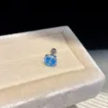 Detailed close-up of a vibrant blue zircon round stud earring on a soft beige velvet tray. - Pair / Silver-Pink-7mm