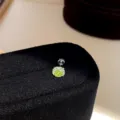 Close-up detail of the sparkling green crystal square stud earring on black velvet stand. - Single Piece / Green-5mm