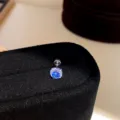Close-up detail shot of a dazzling blue zircon screw back ear stud, glittering elegantly. - Pair / Stud Earrings - Silver & Dark Blue - 7mm
