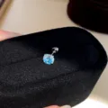 Detailed shot of a Korean-style minimalist colored zircon stud earring with a secure threaded back. - Single Piece / Blue-Green-5mm
