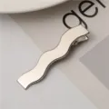 Detailed close-up of a sleek silver wavy metal duckbill hair clip, perfect fashion accessory. - Solid Snake Hair Clips