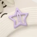 Close-up detail of light purple star-shaped metal snap hair clip for cute daily hairstyles. - Star / Purple