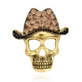 Detailed view of retro rhinestone skull brooch, exquisite cowboy hat design, fashion accessory. - Antique Gold