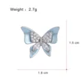 Elegant butterfly brooch crafted with blue enamel and sparkling cubic zirconia stones. 1.8x1.5cm - G097-B (Lapel Pin)