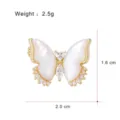 Elegant mother of pearl butterfly brooch in gold plated copper with sparkling cubic zirconia. - G060-H