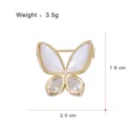Detailed view of the luxury gold-plated butterfly brooch with mother of pearl and zircon. - G086-H