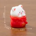 Cute miniature lucky cat figurine in a red fortune bag, displayed with 2.7cm height measurement - 2.7x2.1x2.2cm
