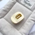 Detail shot of the matte light yellow hollow oval hair claw clip, perfect for daily styling. - 5cm PS Round Grab Clip (20260515e) / Oval-Matte Cream White