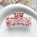 Detailed close-up of a clear pink square hair claw clip featuring cute red cherry and bow print. - Type D Square Thermal Transfer (8.5cm) / Clear