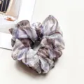 Close-up detail of the sheer chiffon scrunchie featuring chic rhinestone crystal accents and plaid. - Plaid Purple Coffee