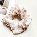 Close up detail of a sheer mesh hair scrunchie with cute pink hearts and sparkling rhinestones. - Heart Pink