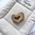 Detail shot of a minimalist matte hollow heart hair claw clip in beige, stylish hair accessory. - 5cm PS Heart Grab Clip (20260515e) / Heart-Matte Light Coffee