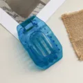 Blue transparent flat hair claw clip, hollow out oval geometric design for women detail view. - Blue