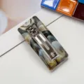 Detailed view of rectangular marble pattern hair barrette with sturdy metal spring clip. - Coffee & Black