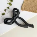 Detailaufnahme der mattschwarzen Haarklammer mit elegantem verschlungenem Schleifendesign. - 10cm / Mattes Schwarz