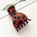 Close-up view of the vintage tortoiseshell hair claw clip featuring hollow design. - Matte Tortoiseshell