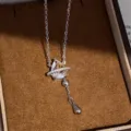 Detailed close-up view of the silver zircon teardrop necklace showcased in velvet box. - Water Drop Tassel Necklace (White) / Silver