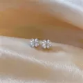 Four-petal flower cubic zirconia stud earrings, elegant detailed view product design. - Silver Earring Post-White