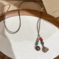 Details of boho retro wooden bead necklace with plant seed pendant on wooden display tray. - 1# Necklace-Coffee