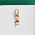 Exquisite metal snowman keychain close-up, featuring vibrant enamel details and a gold clasp. - Snowman