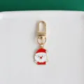 Charming metal Santa Claus keychain pendant detail view, golden hardware, vibrant colors. - Santa Claus
